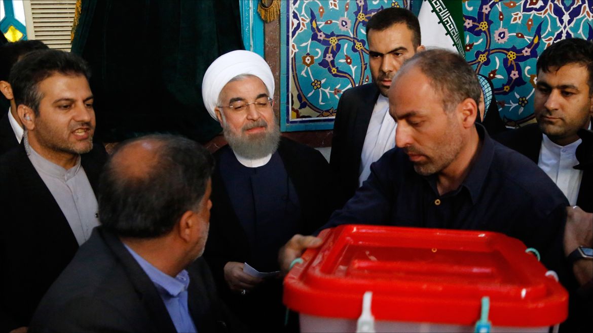 epa05973364 Iranian president Hassan Rouhani (C) casts his ballot in Ershad Mosque polling station during the Iranian presidential elections in Tehran, Iran, 19 May 2017. Out of the candidates, the race is tightest between frontrunners Iranian current president Hassan Rouhani and conservative presidential candidate Ebrahim Raisi.  EPA/ABEDIN TAHERKENAREH