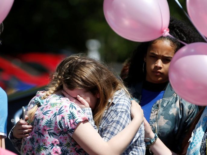 Pupils react outside Tottington high school, after viewing flowers in memory of schoolmate Olivia Campbell who was killed during the Manchester Arena attack, Bury, Manchester, Britain, May 26, 2017. REUTERS/Andrew Yates