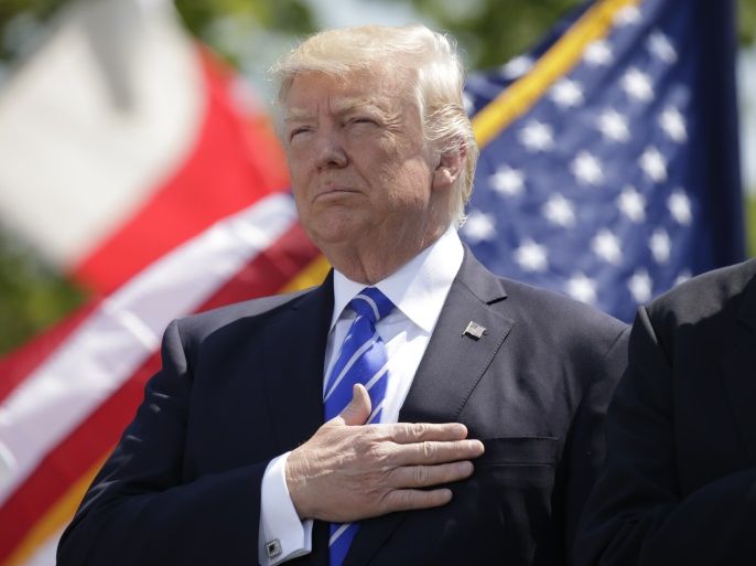 President Donald Trump holds his hand over his heart for the U.S. National Anthem as he attends the Coast Guard Academy commencement ceremonies to address the graduating class in New London, Connecticut, U.S. May 17, 2017. REUTERS/Kevin Lamarque