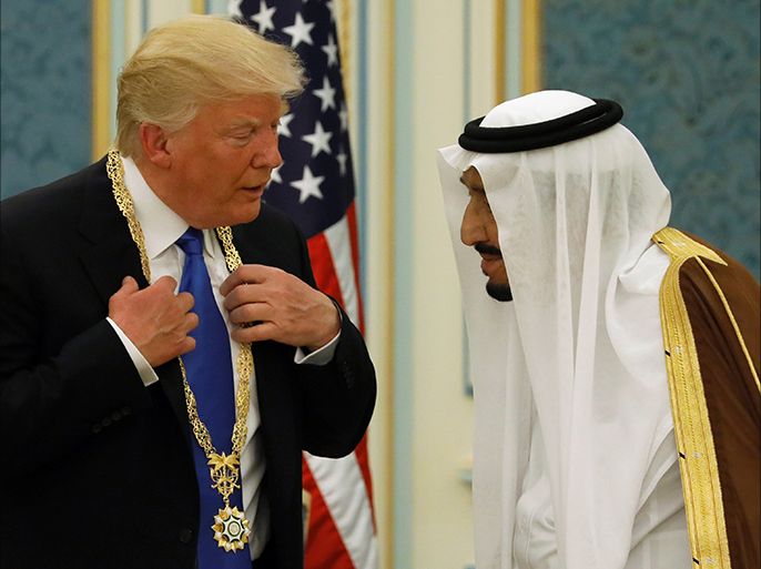 Saudi Arabia's King Salman bin Abdulaziz Al Saud (R) presents U.S. President Donald Trump with the Collar of Abdulaziz Al Saud Medal at the Royal Court in Riyadh, Saudi Arabia May 20, 2017. REUTERS/Jonathan Ernst