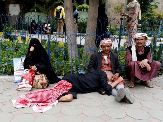Relatives sit next to a sick man waiting to be admitted to a hospital in Sanaa, Yemen May 6, 2017. Picture taken May 6, 2017. REUTERS/Khaled Abdullah