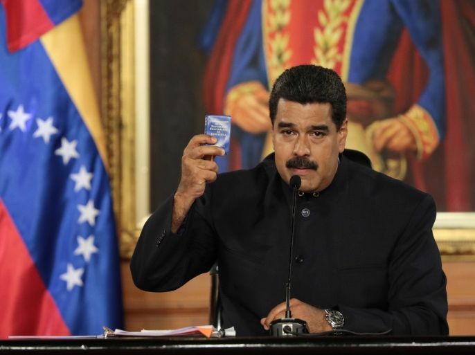 Venezuela's President Nicolas Maduro holds a copy of the Venezuelan constitution as he speaks during a ceremony at Miraflores Palace in Caracas, Venezuela May 1, 2017. Miraflores Palace/Handout via REUTERS ATTENTION EDITORS - THIS PICTURE WAS PROVIDED BY A THIRD PARTY. EDITORIAL USE ONLY. TPX IMAGES OF THE DAY