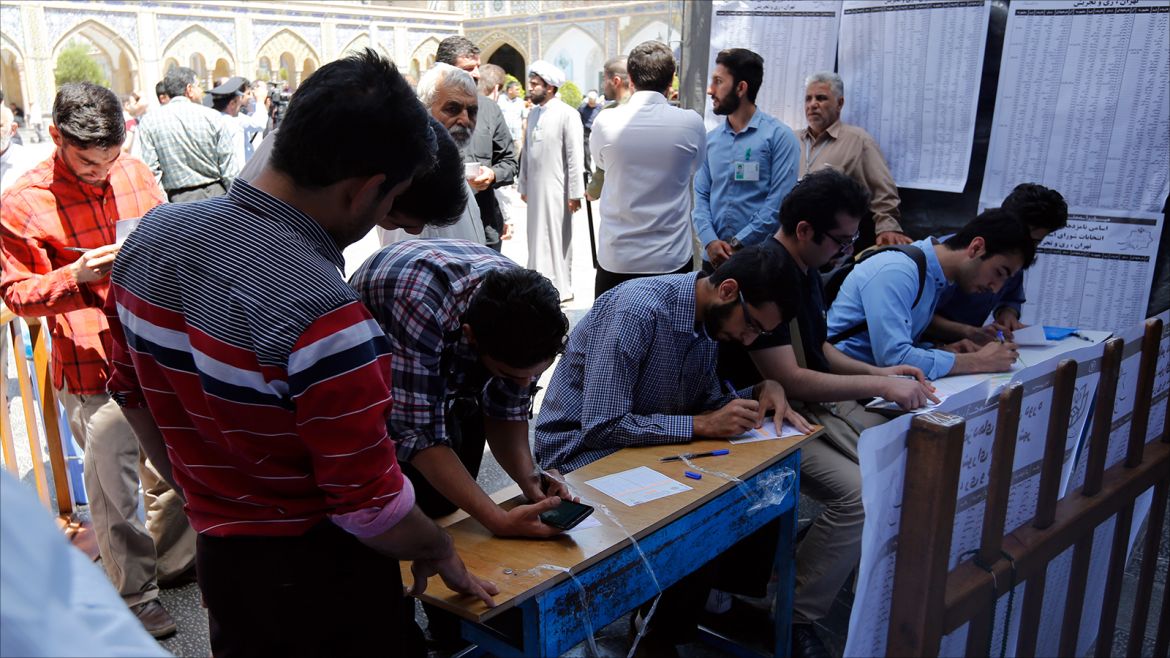 epa05973681 Iranian men fill their ballot papers in the Iranian presidential elections at a polling station set up at the Abdol Azim shrine in the city of Shahre-Ray, south of the capital of Tehran, Iran, 19 May 2017. Out of the group of candidates, the race is tightest between frontrunners Iranian current president Hassan Rouhani and his conservative challenger Ebrahim Raisi.  EPA/ABEDIN TAHERKENAREH