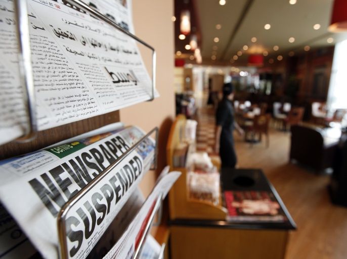 Newspapers with headlines reporting Bahrain has suspended opposition newspaper Al-Wasat are seen in a local coffee shop in Manama April 3, 2011. Bahrain suspended the Gulf Arab state's main opposition newspaper on Sunday, after accusing it of falsifying news about recent sectarian unrest and a government crackdown on protests. REUTERS/Hamad I Mohammed (BAHRAIN - Tags: CIVIL UNREST MEDIA)