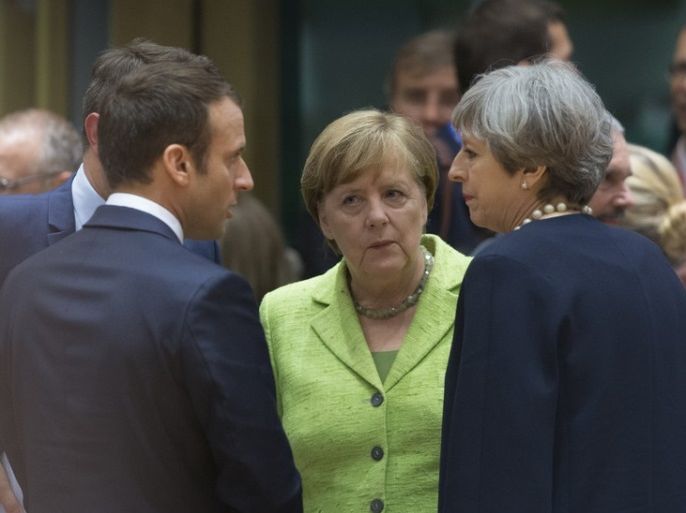 epaselect epa06043234 (L-R) French President Emmanuel Macron, German Chancellor Angela Merkel and Britain's Prime Minister Theresa May speak with each other at the start of a European Council meeting in Brussels, Belgium, 22 June 2017. European heads of states and governments gather for a two-days European Council meeting on 22 and 23 June which will mainly 'focus on the ongoing efforts to strengthen the European Union and protect its citizens through the work on coun
