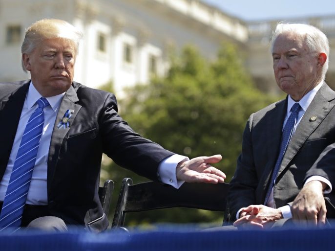 President Donald Trump reaches out toward Attorney General Jeff Sessions as they attend the National Peace Officers Memorial Service on the West Lawn of the U.S. Capitol in Washington, U.S., May 15, 2017. REUTERS/Kevin Lamarque