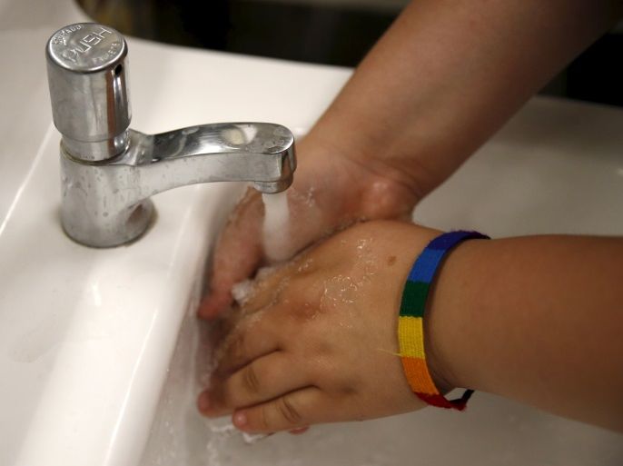A student washes her hands in the first gender-neutral restroom in the Los Angeles school district at Santee Education Complex high school in Los Angeles, California, U.S., April 18, 2016. REUTERS/Lucy Nicholson