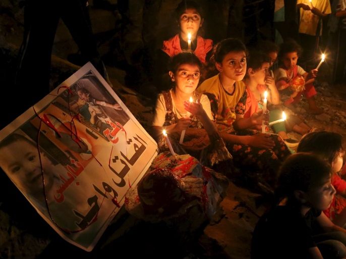 Palestinian children light candles during a rally to remember 18-month-old Palestinian baby Ali Dawabsheh, who was killed after his family's house was set on fire in a suspected attack by Jewish extremists, in Rafah in the southern Gaza Strip August 2, 2015. Suspected Jewish attackers torched a Palestinian home in the occupied West Bank on Friday, killing an 18-month-old toddler and seriously injuring three other family members, an act that Israel's prime minister described as terrorism. REUTERS/Ibraheem Abu Mustafa