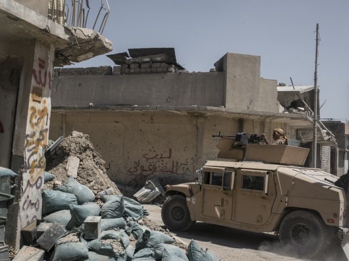 MOSUL, IRAQ -JUNE 23: An Iraqi Army humvee flying a Shia flag passes an Iraqi Army position on June 23, 2017 in the frontline neighbourhood of Tal Aptar, which borders the Islamic State occupied Old City of west Mosul. Iraqi forces continue to encounter stiff resistance with improvised explosive devices, car bombs, heavy mortar fire and snipers hampering their advance. (Photo by Martyn Aim/Getty Images)