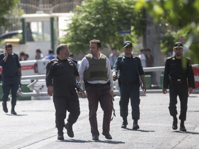 TEHRAN, IRAN - JUNE 7: Police officers walk outside Iran's parliament building following an attack by several gunmen on June 7, 2017 in Tehran, Iran. At least 12 people were killed and dozens more wounded during simultaneous gun and suicide bomb attacks in Iran's capital. A suicide bomber targeted the shrine of Ayatollah Ruhollah Khomeini while several gunmen launched an attack on the parliament building, which is now reportedly over following hours of audible gun-fi