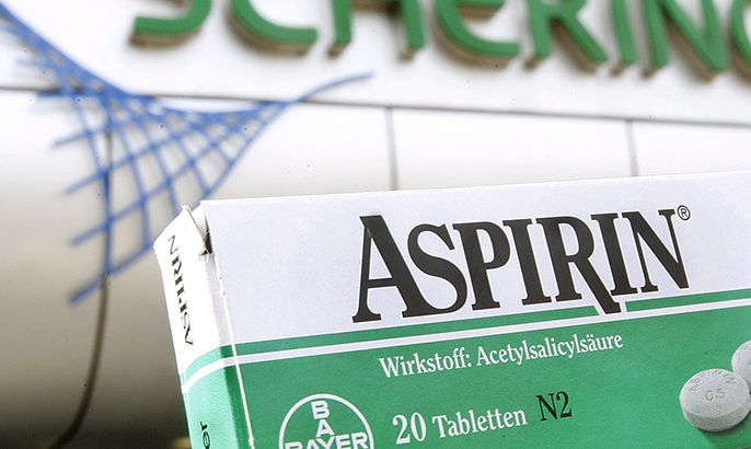 epa00676078 The picture shows a package of Aspirin pain reliever by Bayer in front of the main entrance of Schering AG in Berlin, Germany, Friday 24 March 2006. According to reports of both companies on late Thursday, 23 March 2006, the corporate group Schering and chemical big group Bayer Leverkusen surprisingly agreed on a merger. Photo: Wolfgang Kumm EPA/WOLFGANG KUMM