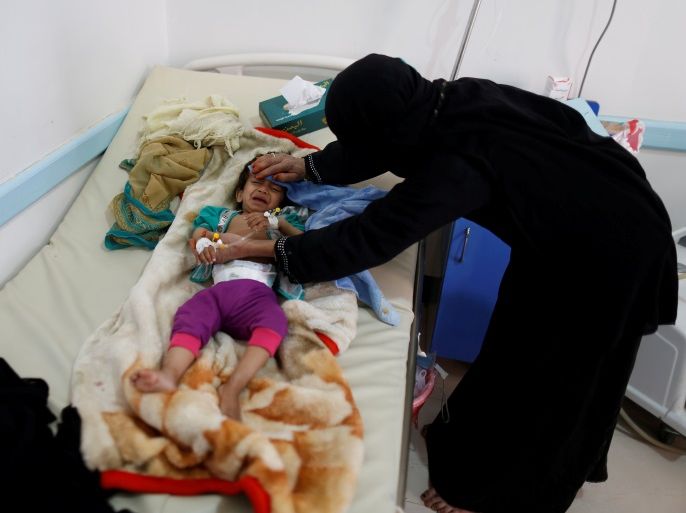 A woman helps her son as he lies on a bed at a cholera treatment center in Sanaa, Yemen June 6, 2017. Picture taken June 6, 2017. REUTERS/Khaled Abdullah TPX IMAGES OF THE DAY