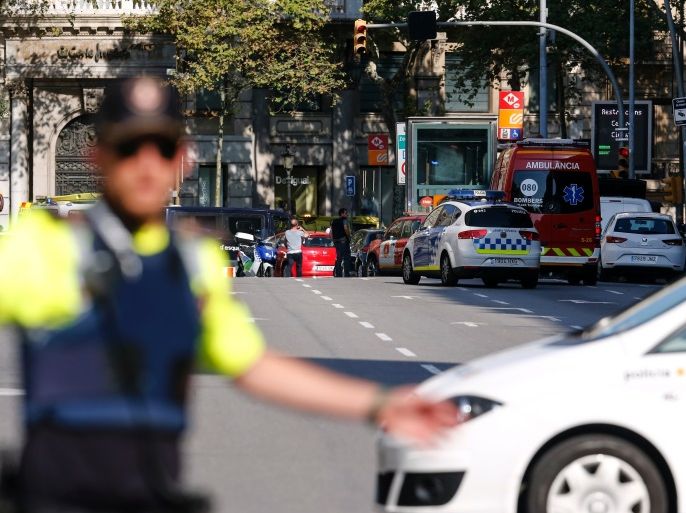 A policemen stand as he blocks the street to a cordoned off area after a van ploughed into the crowd, injuring several persons on the Rambla in Barcelona on August 17, 2017. / AFP PHOTO / PAU BARRENA (Photo credit should read PAU BARRENA/AFP/Getty Images)