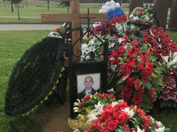A portrait of Russian lieutenant colonel Gennady Perfilyev killed in Syria, is seen covering up his name at the grave at the Federal military memorial cemetery outside Moscow, Russia, July 4, 2017. Picture taken July 4, 2017. REUTERS/Maria Tsvetkova
