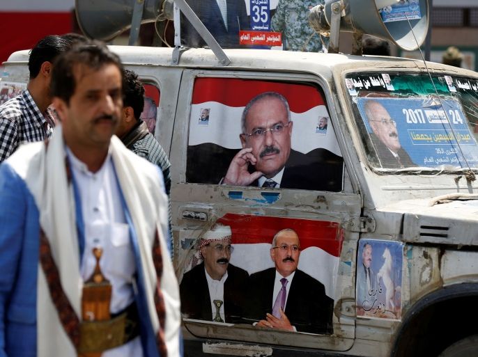 Posters of Yemen's former President Ali Abdullah Saleh are seen on a car at a square where Saleh's party, the General People's Congress, is preparing to hold a rally to mark the 35th anniversary of its establishment in Sanaa, Yemen August 22, 2017. REUTERS/Khaled Abdullah