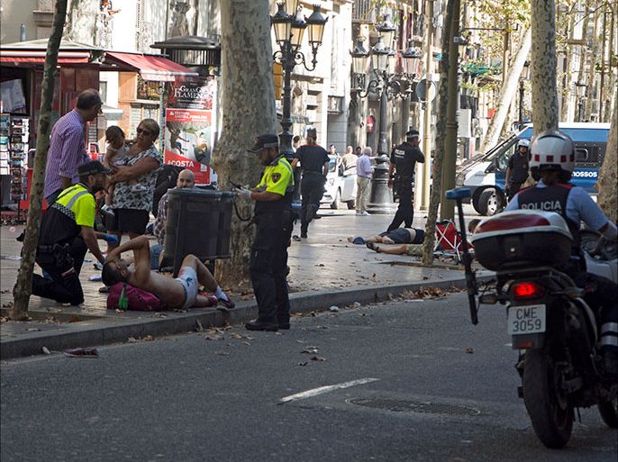 epa06148663 Mossos d'Esquadra Police officers attend injured people after a van crashed into pedestrians in Las Ramblas, downtown Barcelona, Spain, 17 August 2017. According to initial reports a van crashed into a crowd in Barcelona's famous Placa Catalunya square at Las Ramblas area injuring several. Local media report the van driver ran away, metro and train stations were closed. The number of people injured and the reasons behind the incident are not yet known. Official sources have not confirmed that the incident is a terrorist attack. EPA/David Armengou FACES PIXELATED BY SOURCE DUE TO LOCAL LAW