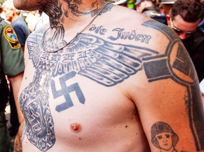 A supporter of the Ku Klux Klan is seen with his tattoos during a rally at the statehouse in Columbia, South Carolina July 18, 2015. REUTERS/Chris Keane