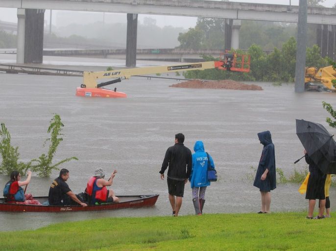 Area residents use a kayak to rescue motorists stranded on Interstate highway 45 which is submerged from the effects of Hurricane Harvey seen during widespread flooding in Houston, Texas, U.S. August 27, 2017. REUTERS/Richard Carson