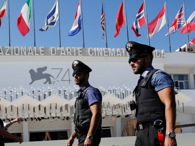 Italian Carabinieri are seen as they patrol in front of the entrance of the Palazzo del Cinema a day before the opening of the 74th Venice Film Festival in Venice, Italy August 29, 2017. REUTERS/Alessandro Bianchi