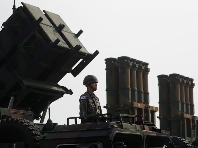 A soldier stands on a a PAC-2 launcher (L) next to medium-range surface-to-air missiles (MSAM) during a photo opportunity ahead of a celebration to mark the 69th anniversary of Korea Armed Forces Day, in Pyeongtaek, South Korea, September 25, 2017. Picture taken on September 25, 2017. REUTERS/Kim Hong-Ji