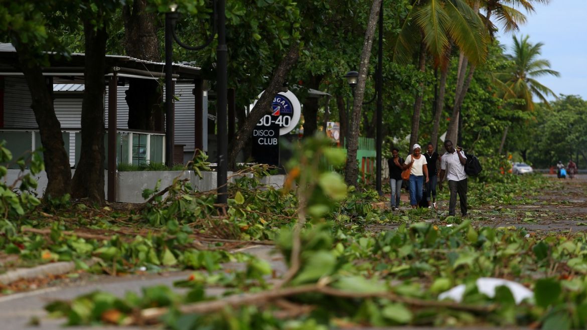 Locals walk along a street covered with fallen trees in the aftermath of Hurricane Irma in Puerto Plata, Dominican Republic, September 8, 2017. REUTERS/Ivan Alvarado
