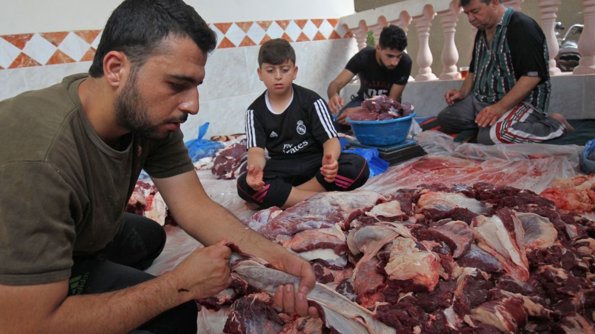 Palestinian men divide meat after slaughtering a bull at a residence in Rafah in the southern Gaza Strip, on September 1, 2017, as part of the commemoration for the first day of Eid al-Adha.Eid al-Adha (the Festival of Sacrifice) is celebrated throughout the Muslim world as a commemoration of Abraham's willingness to sacrifice his son for God, and cows, camels, goats and sheep are traditionally slaughtered on the holiest day. / AFP PHOTO / SAID KHATIB        (Photo credit should read SAID KHATIB/AFP/Getty Images)