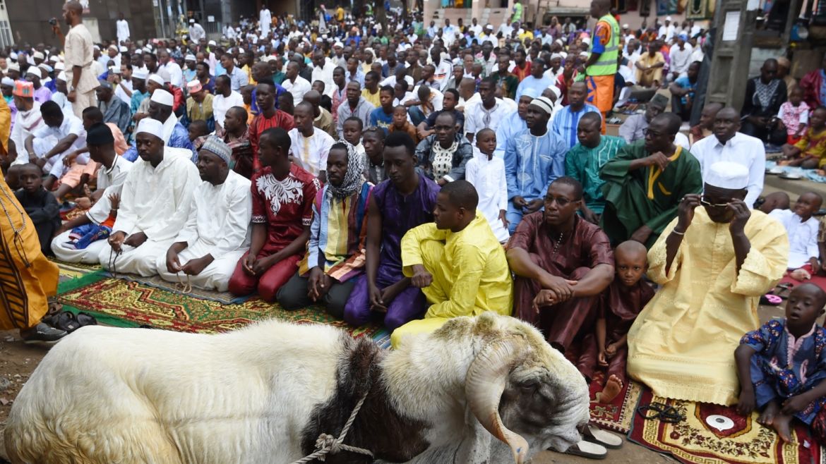 Muslims gather for the Friday noon prayers during Eid al-Adha celebrations in the Adjame district of Abidjan on September 1, 2017.Muslims across the world are preparing to celebrate the annual holiday of Eid al-Adha, or the Festival of Sacrifice, by visiting the tombs of their loved ones and slaughtering sheep, goats, cows and camels, marking the end of the Hajj pilgrimage to Mecca and in commemoration of Prophet Abraham's readiness to sacrifice his son, Ismail, on God