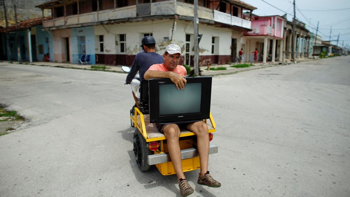 Doctor Alberto Rodriguez takes a television from his home to a safer place prior to the arrival of the Hurricane Irma in Caibarien, Cuba, September 8, 2017. REUTERS/Alexandre Meneghini