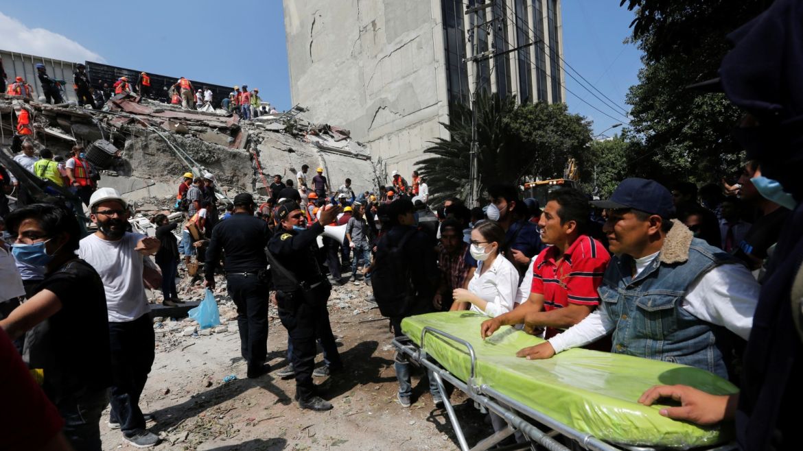 Paramedics wait as rescue personnel search for people in the rubble of a collapsed building after an earthquake hit Mexico City, Mexico September 19, 2017. REUTERS/Claudia Daut