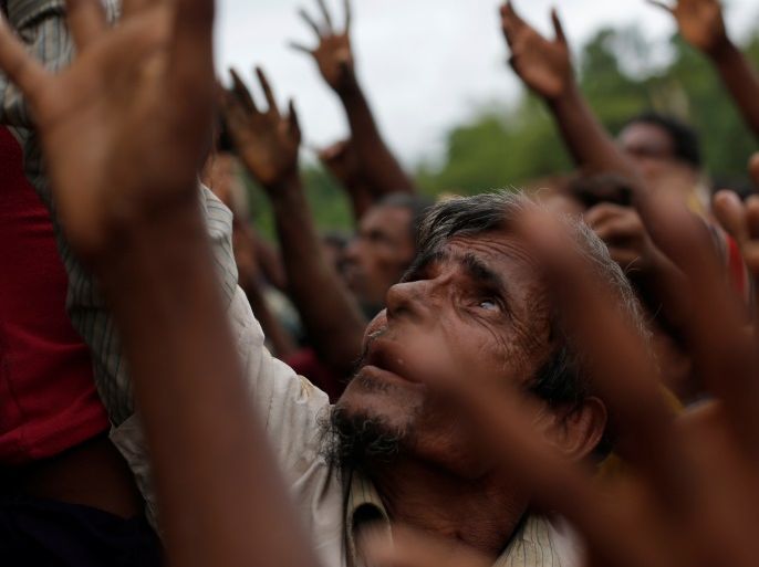 Rohingya refugees stretch their hands to receive food distributed by local organizations in Kutupalong, Bangladesh, September 9, 2017. REUTERS/Danish Siddiqui