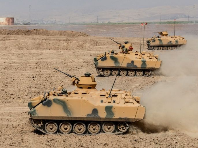 Turkish soldier ride armoured vehicles near the Habur crossing gate between Turkey and Iraq during a military drill on September 27, 2017 in the Silopi district, southeast Turkey. Iraqi soldiers on September 26 took part in a Turkish military drill close to the Iraqi border on Tuesday, an AFP photographer said, a day after Iraq's Kurdish region held a vote on independence. / AFP PHOTO / ILYAS AKENGIN (Photo credit should read ILYAS AKENGIN/AFP/Getty Images)
