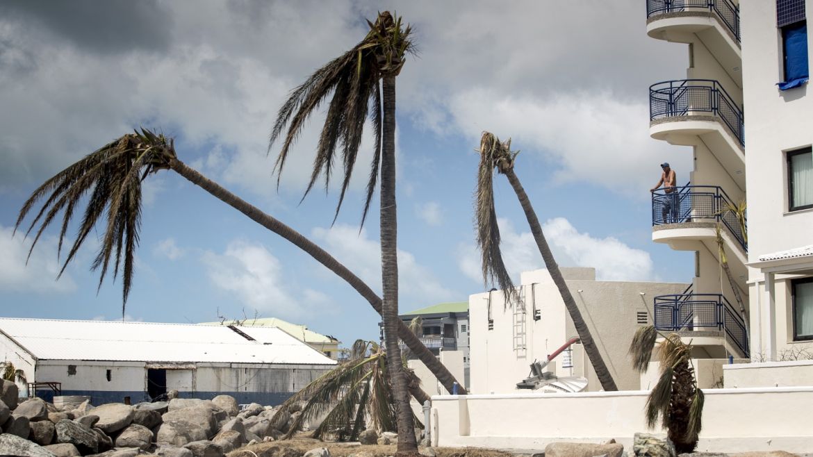 This handout photograph provided courtesy of the Dutch Department of Defense on September 8, 2017 shows a man looking on over the devastion of Hurricane Irma on the Dutch Caribbean island of Sint Maarten.Hurricane Irma killed two people and wounded 43 others when it barrelled through the Dutch part of the Caribbean island of Saint Martin, a Dutch official said September 8. / AFP PHOTO / DUTCH DEFENSE MINISTRY / GERBEN VAN ES / Netherlands OUT / RESTRICTED TO EDITORIAL USE - MANDATORY CREDIT 'AFP PHOTO / DUTCH DEFENSE MINISTRY/GERBEN VAN ES' - NO MARKETING NO ADVERTISING CAMPAIGNS - DISTRIBUTED AS A SERVICE TO CLIENTS        (Photo credit should read GERBEN VAN ES/AFP/Getty Images)