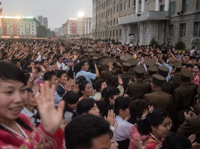 This photo taken on September 6, 2017 shows a mass celebration in Pyongyang for scientists involved in carrying out North Korea's largest nuclear blast to date, on Kim Il-Sung Sqaure.Citizens of the capital lined the streets September 6 to wave pink and purple pom-poms and cheer a convoy of buses carrying the specialists into the city, and toss confetti over them as they walked into Kim Il-Sung Square. / AFP PHOTO / Kim Won-Jin (Photo credit should read KIM WON-