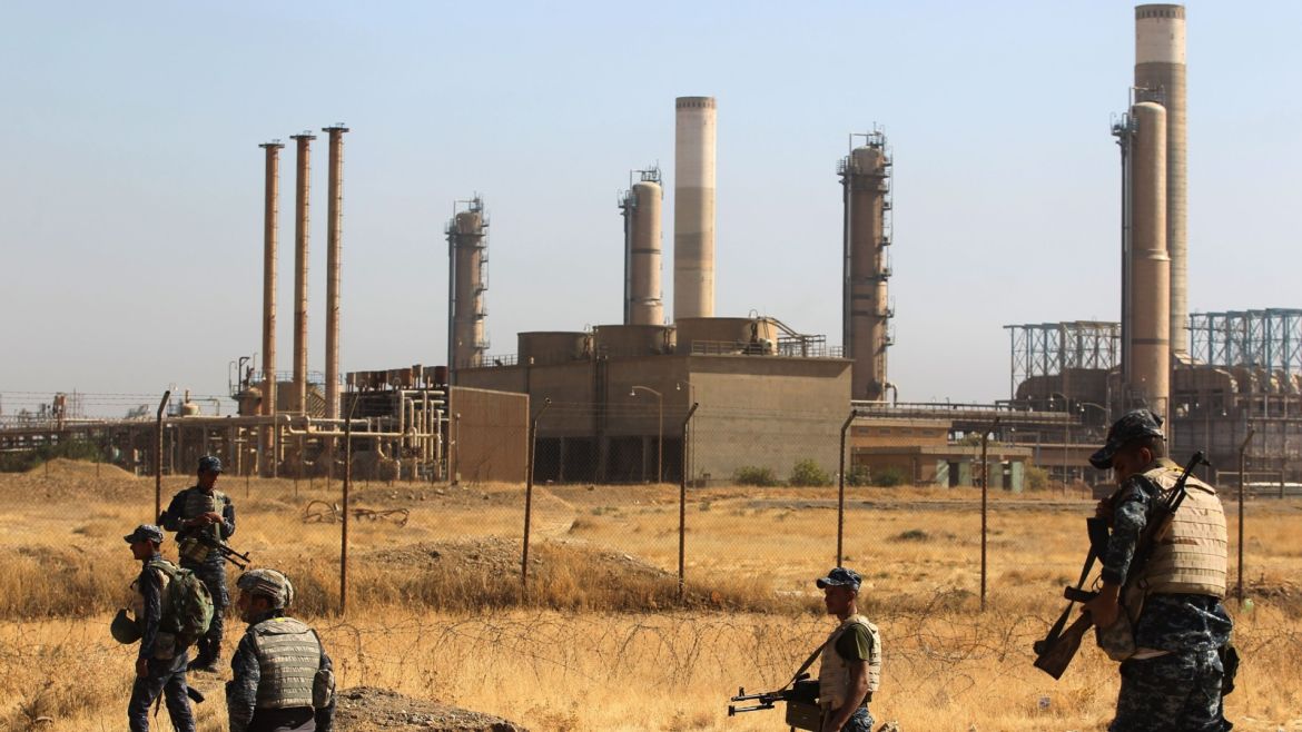 Iraqi forces walk past an oil production plant as they head towards the city of Kirkuk during an operation against Kurdish fighters on October 16, 2017. Iraqi forces clashed with Kurdish fighters near the disputed city of Kirkuk, seizing a key military base and other territory in a major operation sparked by a controversial independence referendum. / AFP PHOTO / AHMAD AL-RUBAYE        (Photo credit should read AHMAD AL-RUBAYE/AFP/Getty Images)