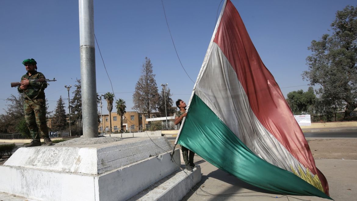 An Iraqi forces member takes down a Kurdish flag as they advance towards the centre of Kirkuk during an operation against Kurdish fighters on October 16, 2017. Iraqi forces seized the Kirkuk governor's office, key military sites and an oil field as they swept across the disputed province following soaring tensions over an independence referendum. / AFP PHOTO / AHMAD AL-RUBAYE        (Photo credit should read AHMAD AL-RUBAYE/AFP/Getty Images)