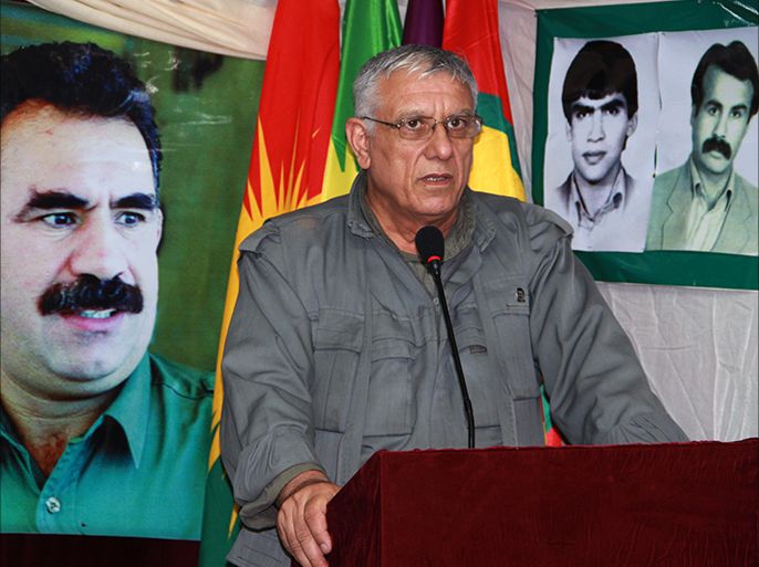 epa04879926 An undated picture made avaliable 11 August 2015 shows Cemil Bayik, one of the five founders of the Kurdistan Workers' Party (PKK), standing in front of a picture of the spiritual leader, Abdullah ضcalan, during an interview, in the Qandil Mountains, Iraq. According to local reports 10 August 2015, Bayik has accused Turkey of protecting the group calling themselves Islamic State (IS) as airstrikes disproportionately target the PKK and not IS. Turkey has resumed airstrikes against PKK positions in both Turkey and Northern Iraq, following a number of attacks throughout Turkey as peace talks between AKP and the PKK broke down. EPA/STR