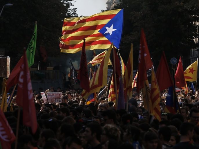Students wave Catalan pro-independence 'Estelada' flags during a protest in front of the Generalitat Palace (Catalan government) in Barcelona on October 26, 2017. Thousands of students rallied in Barcelona today in support of Catalan independence and against plans by Spain's central government to curb the region's powers. The demonstrators carried red carnations and wore red and yellow Catalan independence flags tied around their necks and they made their way through the centre of the Catalan capital chanting: 'occupation forces out!'. / AFP PHOTO / PAU BARRENA (Photo credit should read PAU BARRENA/AFP/Getty Images)