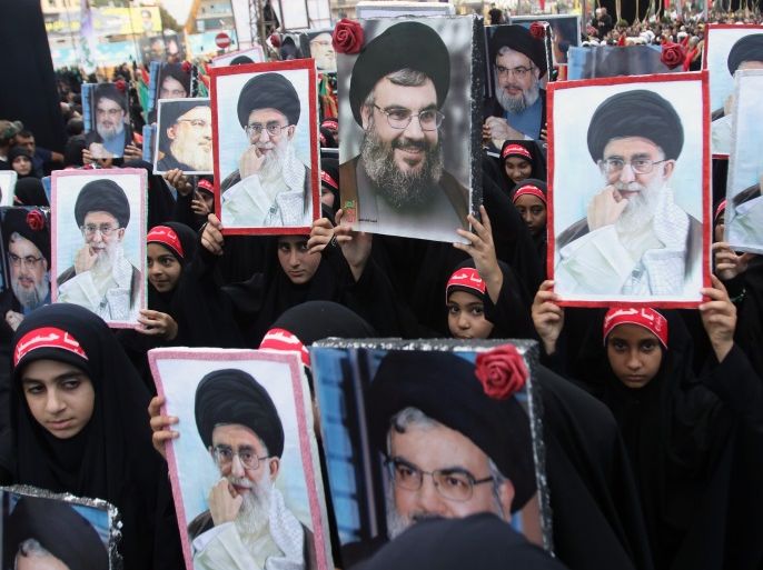 Children of members of Lebanon's Shiite Hezbollah movement hold portraits of Hezbollah chief Hasan Nasrallah (C) and Iran's supreme leader Ayatollah Ali Khamenei during a procession following the mourning period of Ashura in the southern Lebanese city of Nabatieh on October 4, 2017. / AFP PHOTO / Mahmoud ZAYYAT (Photo credit should read MAHMOUD ZAYYAT/AFP/Getty Images)
