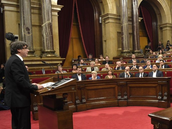 Catalan regional government president Carles Puigdemont (L) gives a speech at the Catalan regional parliament in Barcelona on October 10, 2017.Spain's worst political crisis in a generation will come to a head as Catalonia's leader could declare independence from Madrid in a move likely to send shockwaves through Europe. / AFP PHOTO / LLUIS GENE (Photo credit should read LLUIS GENE/AFP/Getty Images)