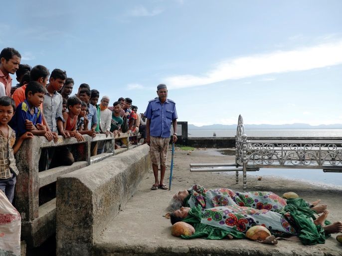 ATTENTION EDITORS - VISUAL COVERAGE OF SCENES OF INJURY OR DEATH Local residents gather around bodies of Rohingya refugees from Myanmar who were killed when their boat capsized on the way to Bangladesh, in Shah Porir Dwip, in Teknaf, near Cox's Bazar in Bangladesh October 9, 2017. REUTERS/Damir Sagolj TEMPLATE OUT