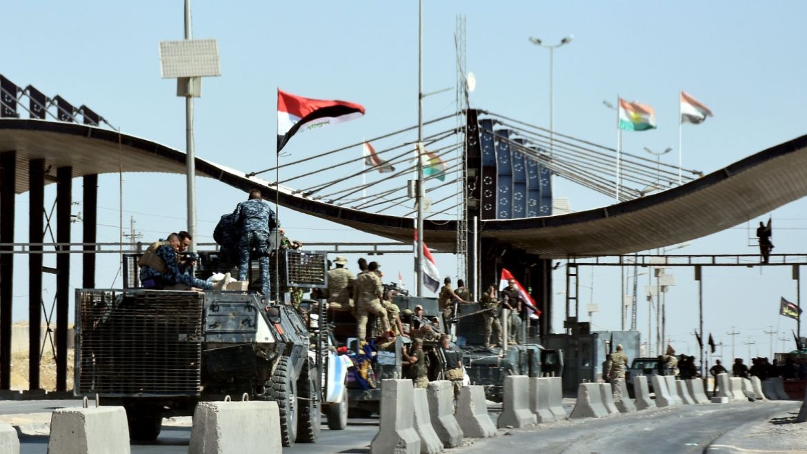 Iraqi forces are seen at the entrance to the military airport after they retook it from Kurdish fighters near the disputed city of Kirkuk on October 16, 2017, in a major operation sparked by a controversial independence referendum.Thousands of residents fled Kurdish districts of Kirkuk for fear of clashes after Iraqi military forces launched operations against Kurdish fighters near the northern city, an AFP journalist said. / AFP PHOTO / Marwan IBRAHIM        (Photo credit should read MARWAN IBRAHIM/AFP/Getty Images)