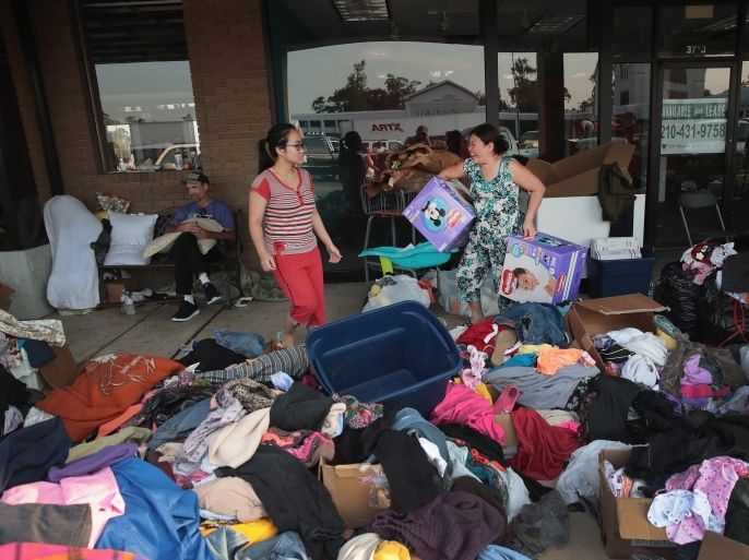 ORANGE, TX - SEPTEMBER 03: Flood victims search through donated items after torrential rains pounded Southeast Texas following Hurricane and Tropical Storm Harvey causing widespread flooding on September 3, 2017 in Orange, Texas. Harvey, which made landfall north of Corpus Christi August 25, has dumped nearly 50 inches of rain in and around areas Houston. (Photo by Scott Olson/Getty Images)