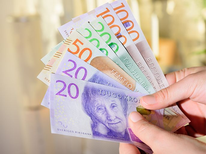 Woman holding new swedish bank notes. NOTE: the new 2015 model - swedish currency