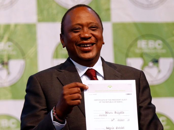 Incumbent President Uhuru Kenyatta holds the certificate of President-Elect of the Republic of Kenya after he was announced winner of the repeat presidential election at the IEBC National Tallying centre at the Bomas of Kenya, in Nairobi REUTERS/Thomas Mukoya