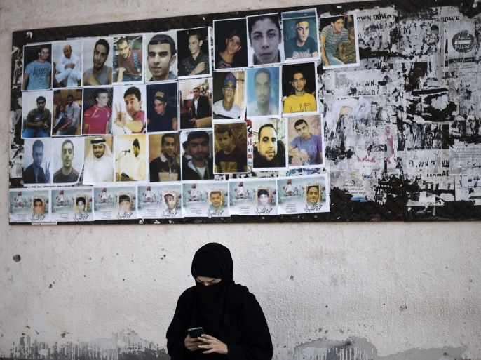 A Bahraini woman sits near portraits of jailed political activists and protesters killed during clashes with police, before taking part in a demonstration to mark the fifth anniversary of the Arab Spring-inspired uprising in the mainly Shiite village of Sitra, south of Manama, on February 12, 2016. / AFP / MOHAMMED AL-SHAIKH (Photo credit should read MOHAMMED AL-SHAIKH/AFP/Getty Images)