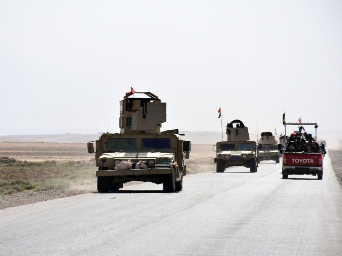 Iraqi army reinforcements drive down a road, linking Hawija to Kirkuk, near the village of Khabbaz on October 7, 2017.Coalition-backed Iraqi forces ousted IS from second city Mosul in July, going on to inflict a string of defeats on the jihadist group. After seizing the northern town of Tal Afar in August, they focused their efforts on Hawija and the Euphrates river area close to the Syrian frontier. / AFP PHOTO / Marwan IBRAHIM (Photo credit should read MARWAN IBRAHIM/AFP/Getty Images)