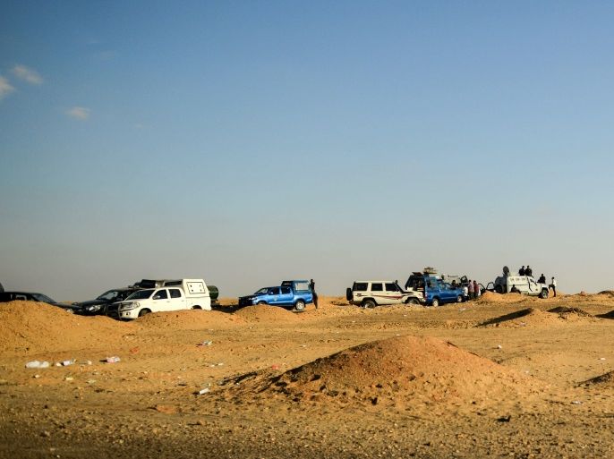 A picture taken on October 21, 2017 shows Egyptian security forces' vehicles and armoured personnel carriers (APCs) parked on the desert road towards the Bahariya oasis in Egypt's Western desert, about 135 kilometres (83 miles) southwest of Giza, near the site of an attack that left dozens of police officers killed in an ambush by Islamist fighters.An official statement said a number of the attackers were killed, but did not give any figures for losses on either side.