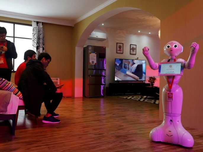 A robot demonstrates a smart home system inside an exhibition venue during Alibaba Group's 11.11 Singles' Day global shopping festival in Shenzhen, China November 11, 2016. REUTERS/Bobby Yip