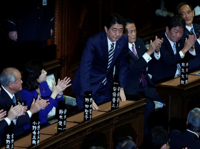 Japan's Prime Minister Shinzo Abe (C) stands as he is re-elected as prime minister while his party lawmakers clap their hands at the Lower House of Parliament in Tokyo, Japan, November 1, 2017. REUTERS/Toru Hanai