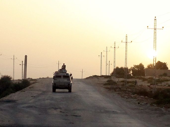 FILE PHOTO: An Egyptian military vehicle is seen on the highway in northern Sinai, Egypt, May 25, 2015. To match Special Report EGYPT-POLITICS/SINAI REUTERS/Asmaa Waguih/File Photo